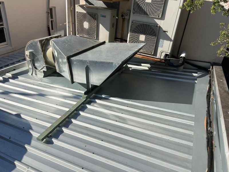 A commercial metal roof with plant and ducting