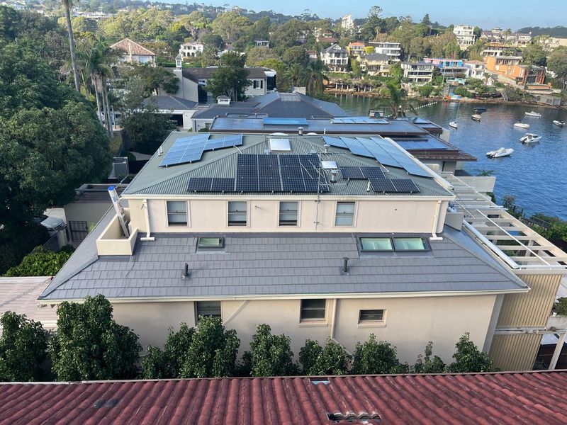 A completed metal roof on a harbourside Sydney home, water visible behind